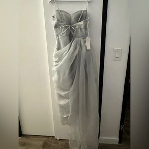 Sleeveless prom dress with a corset and a leg slit. Has adjustable straps